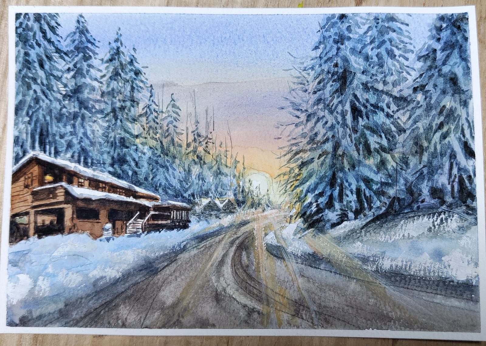 Watercolor of a snowy forest road passing a wooden cabin at dusk
