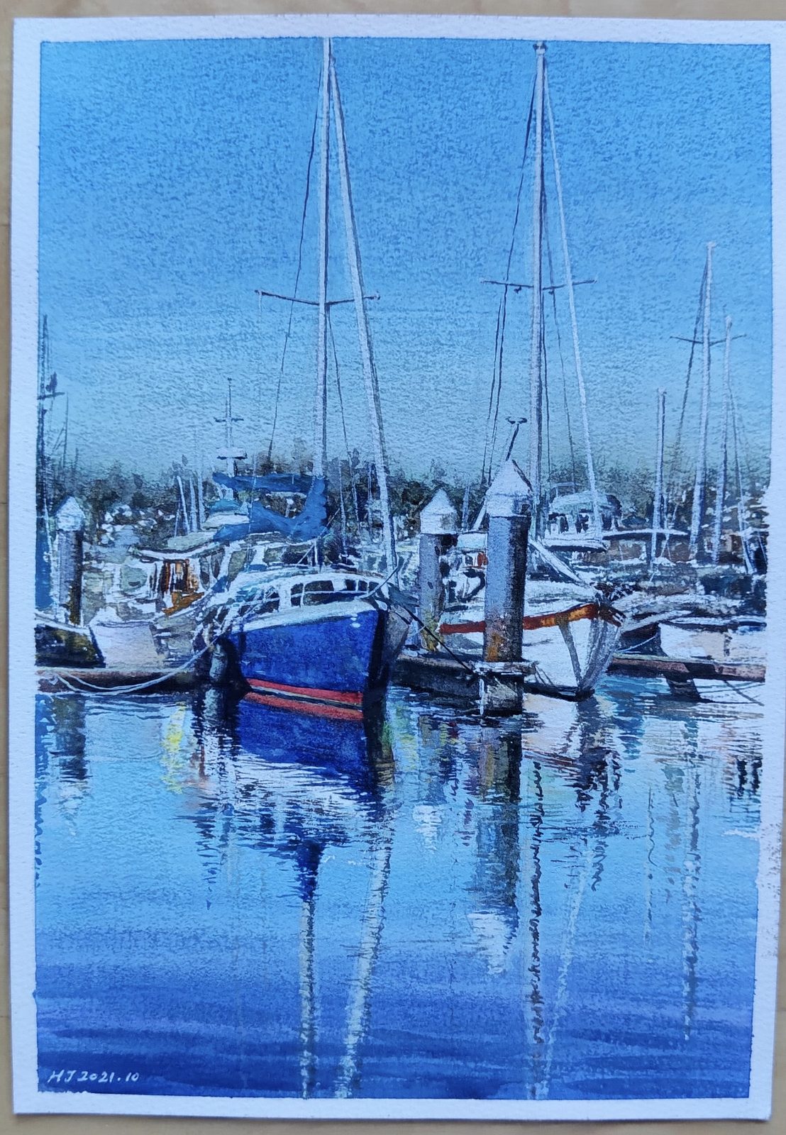 Watercolor of sailboats and their reflections in a calm marina