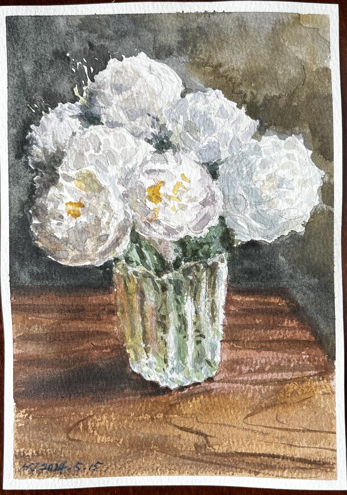 Watercolor of white peonies in a glass vase on a wooden table
