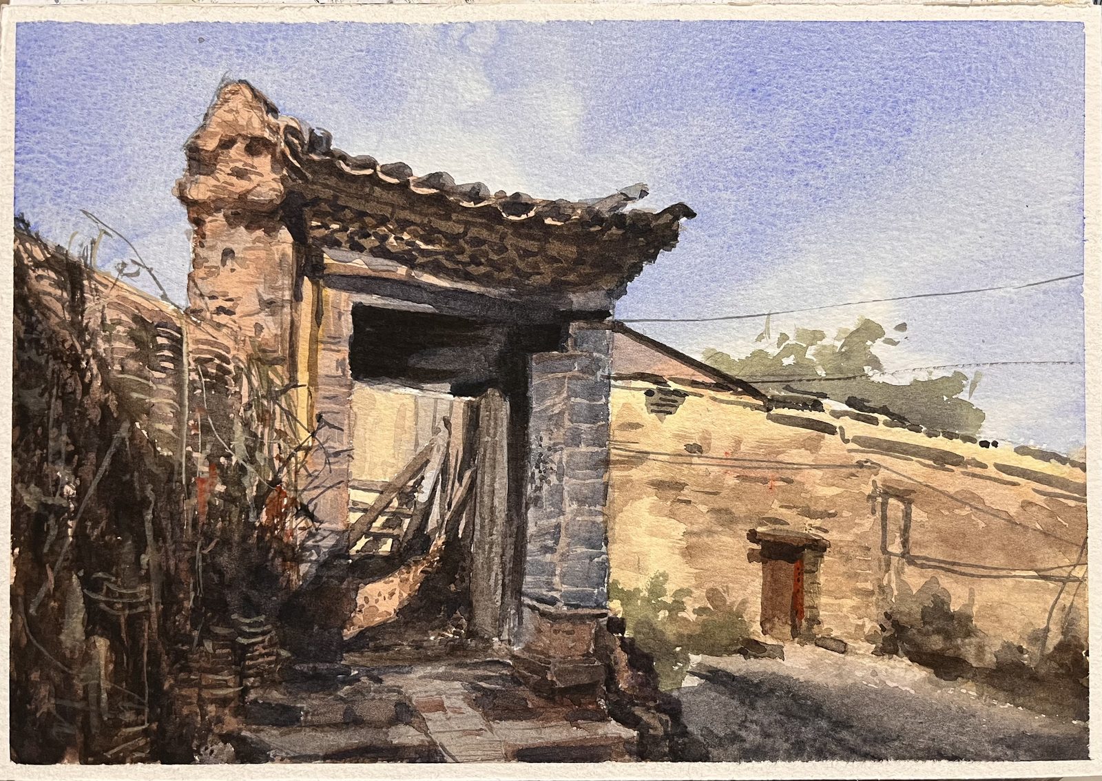 Watercolor of a weathered stone gatehouse in a village lane